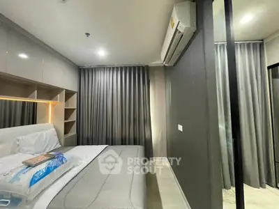 Modern bedroom with sleek design and air conditioning in a stylish apartment.