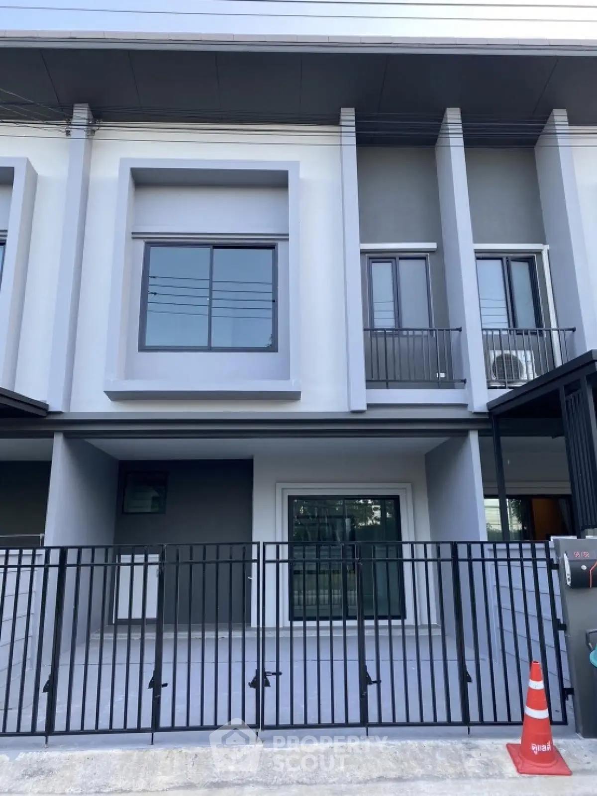 Modern townhouse exterior with sleek design and gated entrance