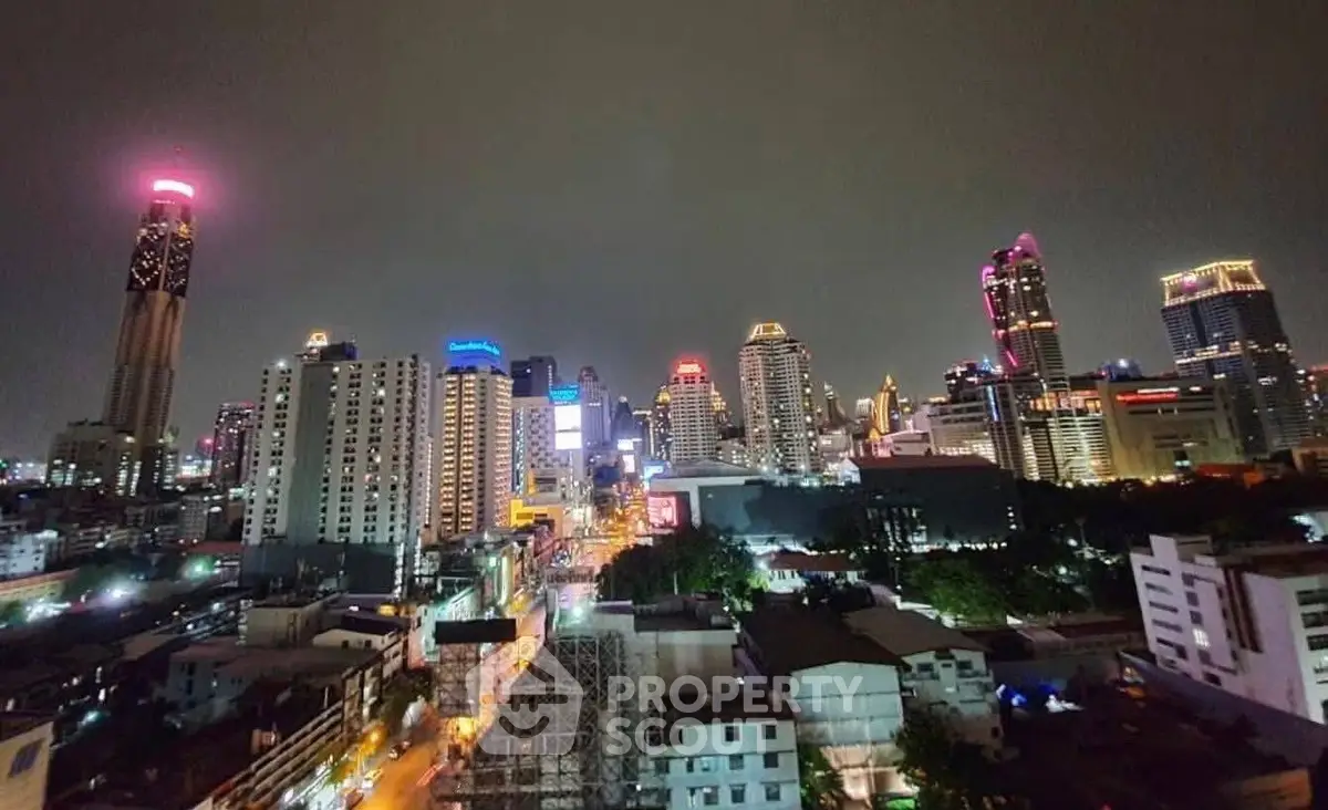Stunning cityscape view of illuminated skyscrapers at night, showcasing vibrant urban living.