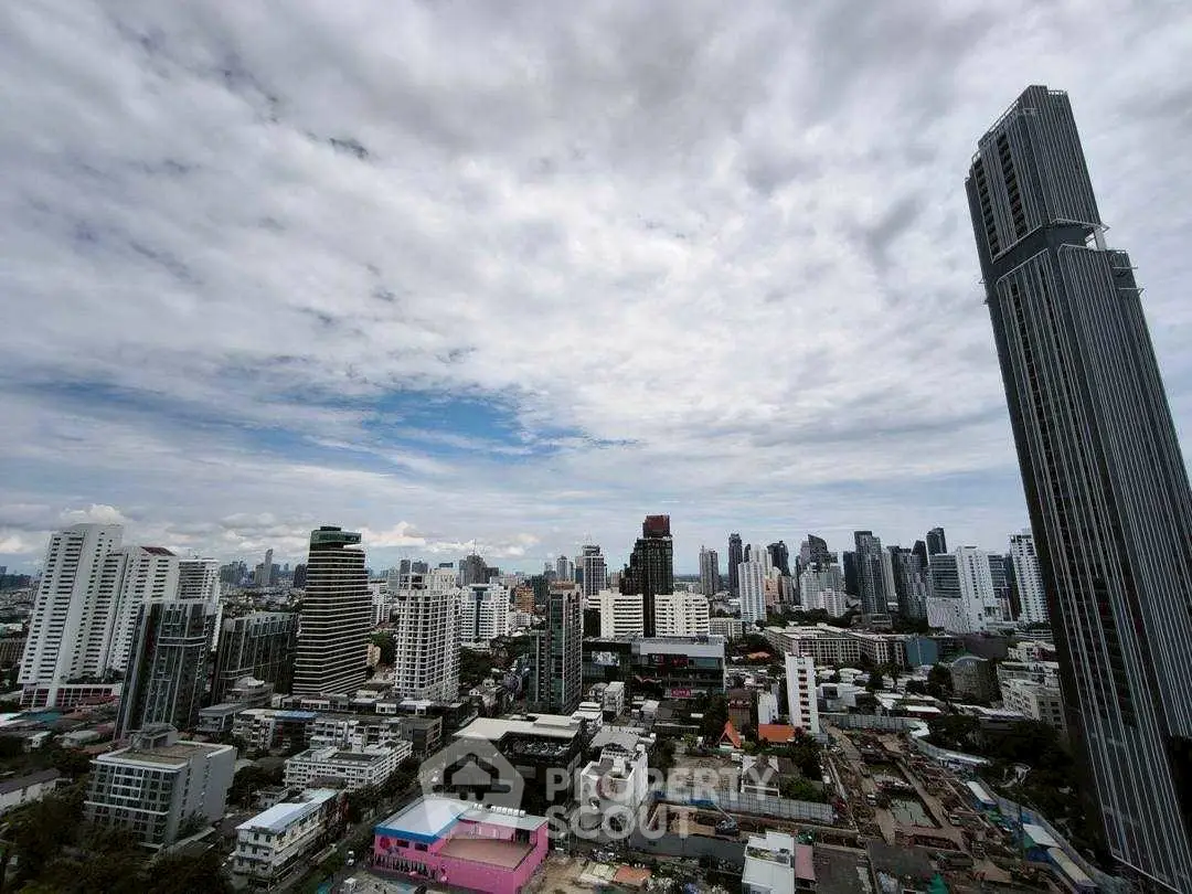 Stunning cityscape view with towering skyscrapers and vibrant skyline under a dramatic cloudy sky.