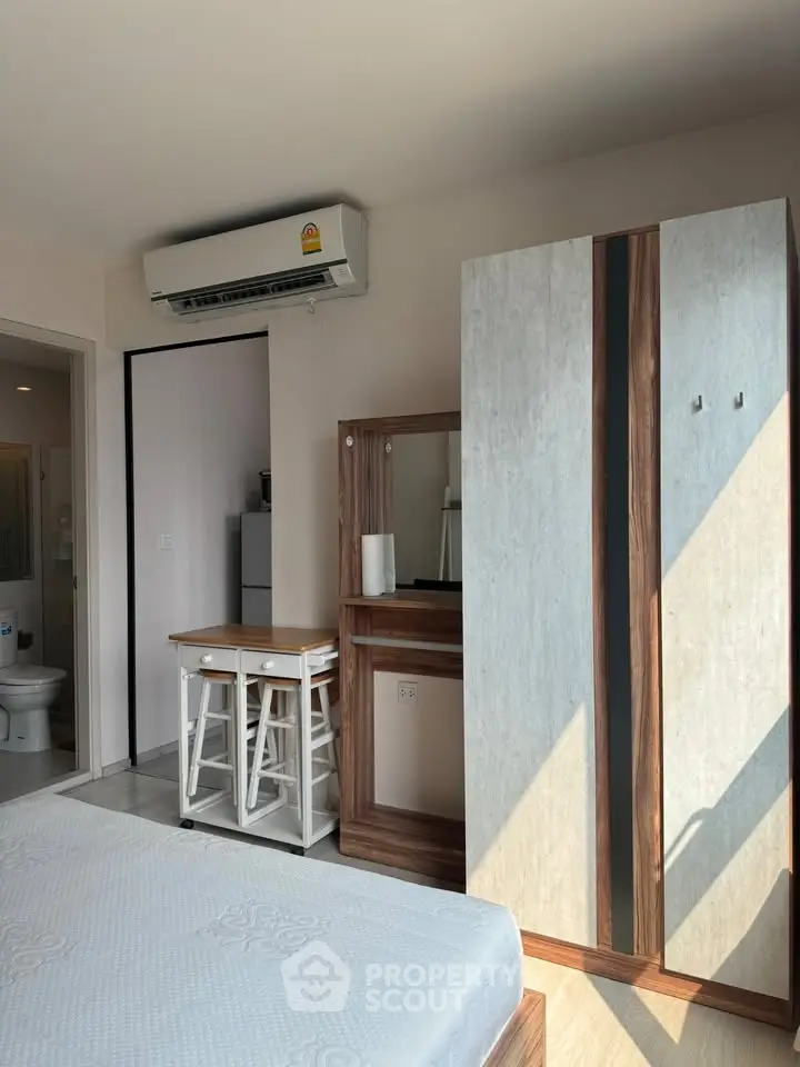 Modern bedroom with air conditioning and stylish furniture