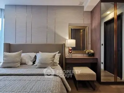 Luxurious bedroom with elegant decor and modern furnishings, featuring a cozy bed and stylish vanity area.