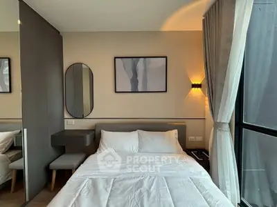 Modern bedroom with stylish decor and large window for natural light