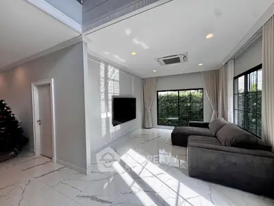 Spacious modern living room with large windows and elegant decor