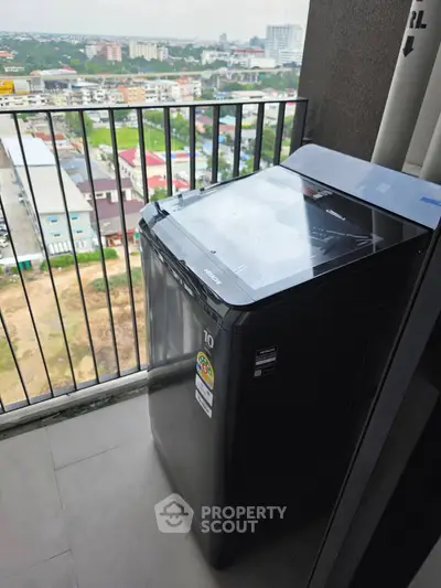 Modern balcony with washing machine and city view, perfect for urban living convenience.