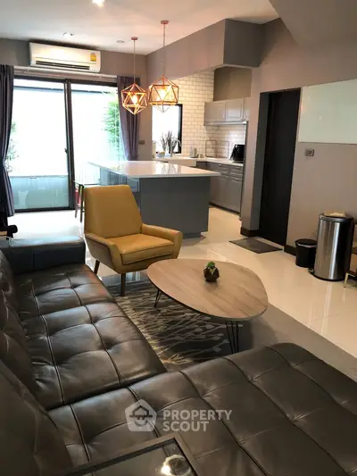 Modern living room with stylish kitchen and cozy seating area