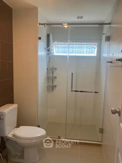 Modern bathroom with glass shower enclosure and sleek fixtures