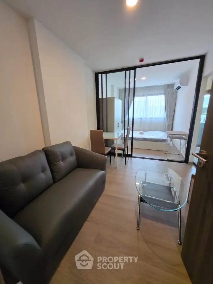 Modern studio apartment with cozy living area and bedroom partition