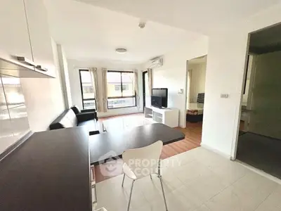 Modern open-plan living room with sleek furniture and natural light