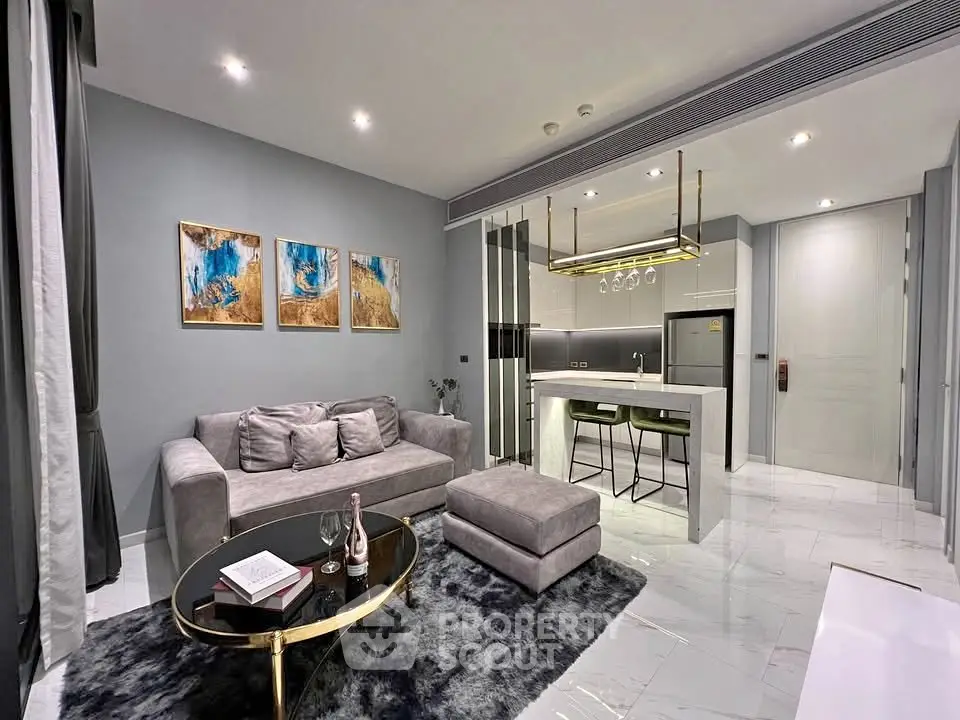 Modern living room with stylish decor and open kitchen layout in luxury apartment.