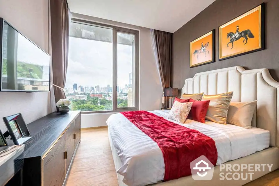 Luxurious bedroom with city view, elegant decor, and large window for natural light.