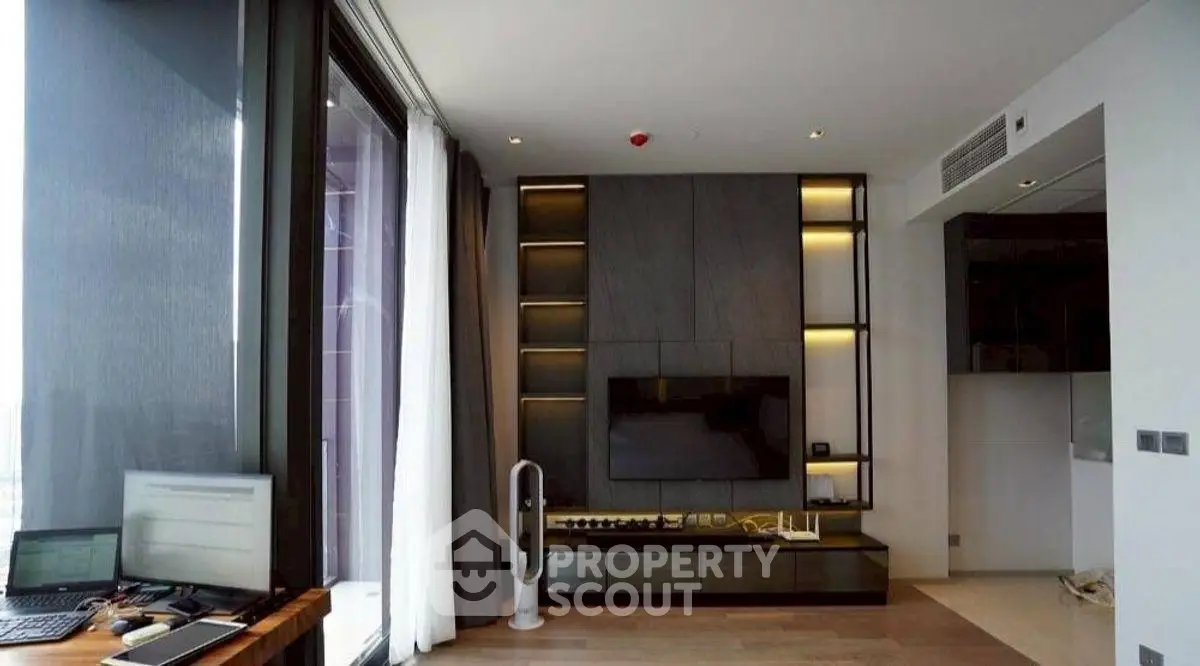 Modern living room with sleek design and large windows offering natural light.