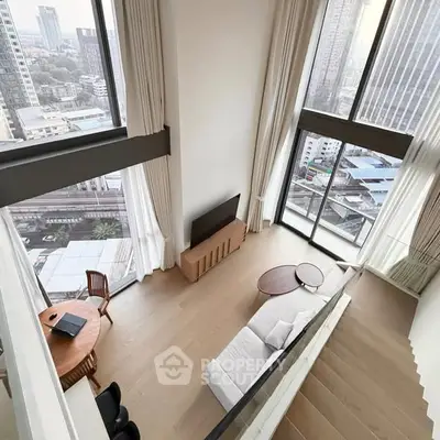 Stunning high-rise living room with floor-to-ceiling windows and breathtaking city views.