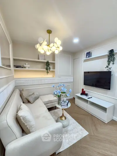 Modern living room with elegant decor, featuring a cozy sofa, stylish lighting, and a sleek entertainment unit.