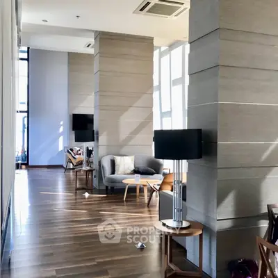 Spacious modern living area with stylish furniture and large windows for natural light.
