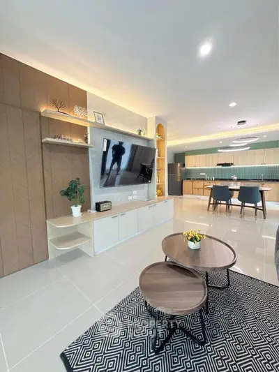 Modern open-plan living room with stylish decor and spacious kitchen area