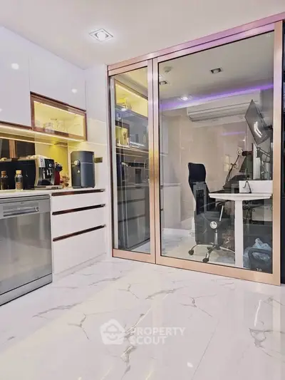 Modern kitchen with sleek appliances and adjacent glass-enclosed study area, perfect for multitasking professionals.