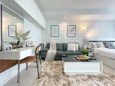 Modern studio apartment with stylish decor, cozy living area, and elegant furnishings.
