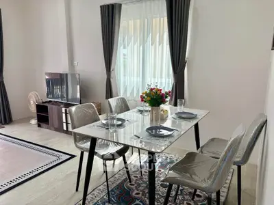 Modern dining area with elegant table setting and natural light