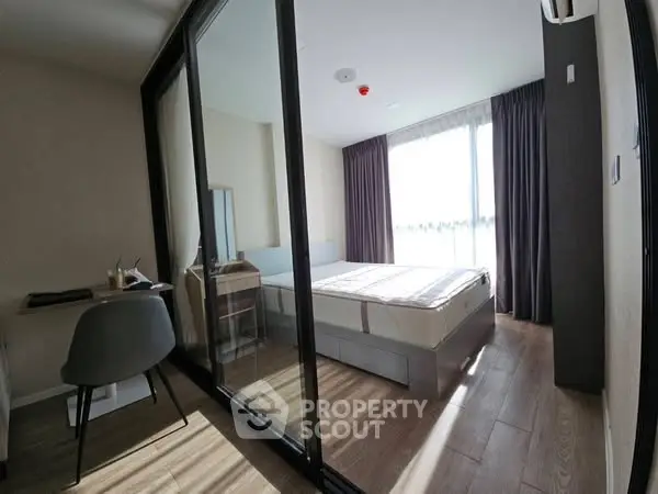 Modern bedroom with glass partition and natural light