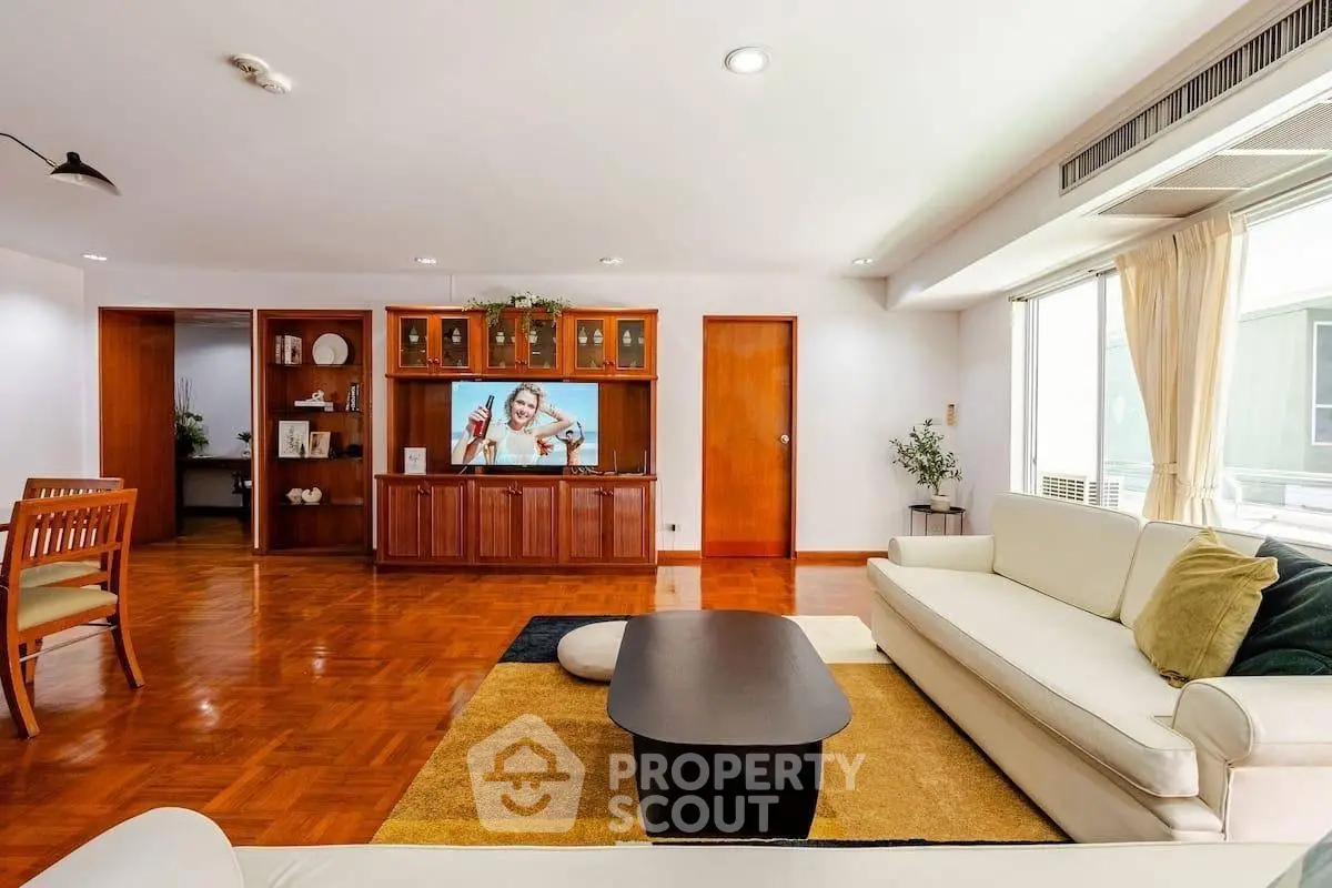 Spacious living room with modern decor and large windows for natural light.