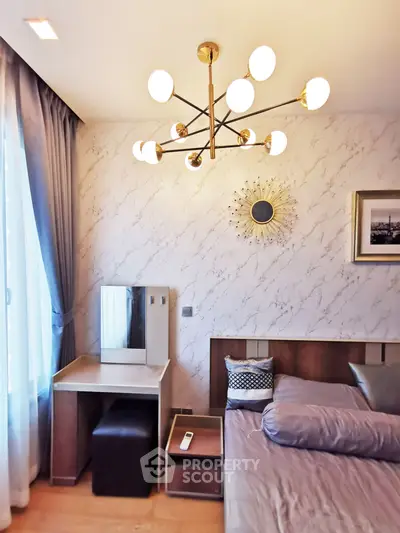 Elegant bedroom with modern chandelier and stylish decor