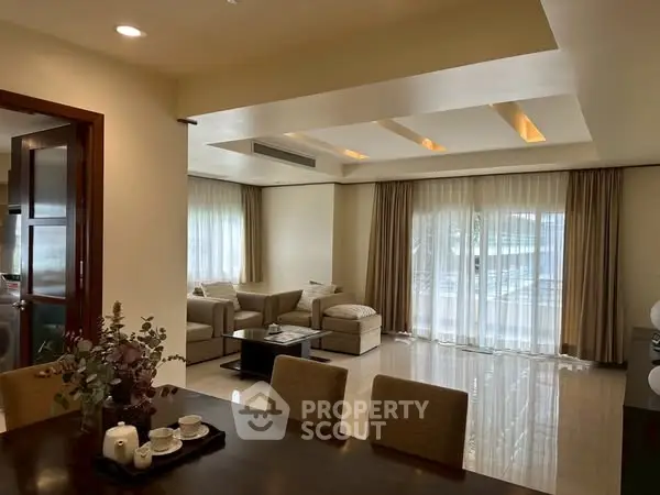 Spacious living room with elegant decor and large windows for natural light.