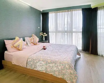 Spacious bedroom with large windows and elegant decor in modern apartment