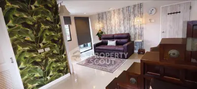 Stylish living room with unique wallpaper and cozy seating area