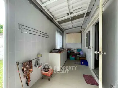 Functional storage area with ample shelving and natural light, perfect for organizing household items.