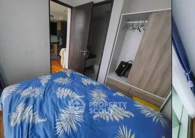 Cozy bedroom with modern wardrobe and stylish bedding in a contemporary apartment.