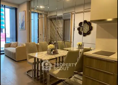 Luxurious modern living room with mirrored walls and elegant dining area