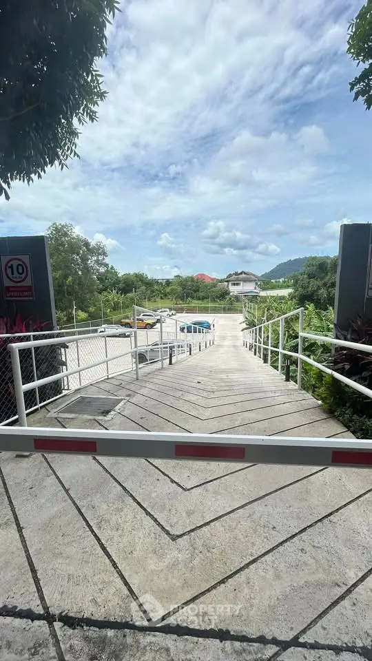Scenic entrance with lush greenery and distant mountain views