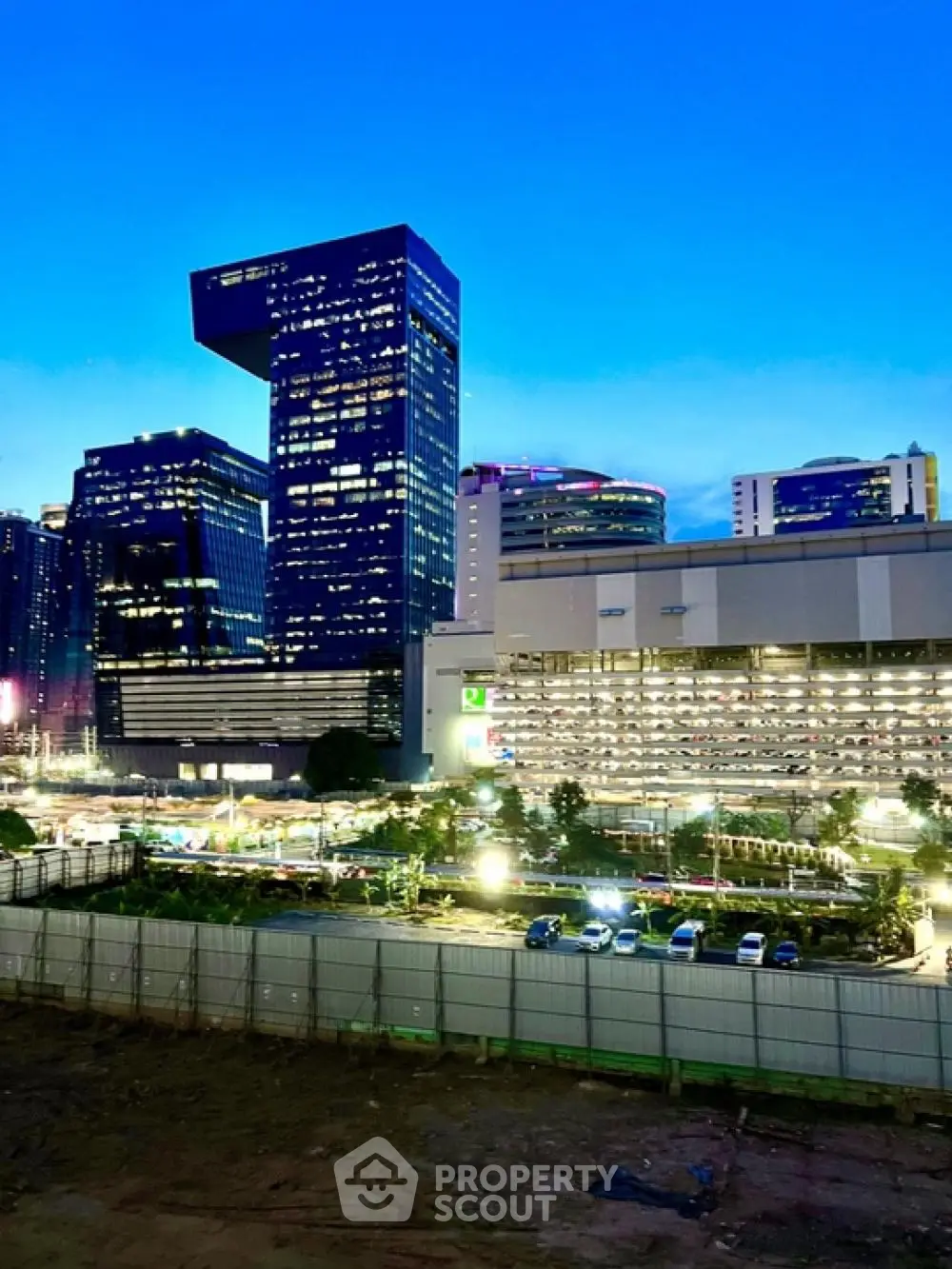 Stunning cityscape view with modern skyscrapers and vibrant evening lights.