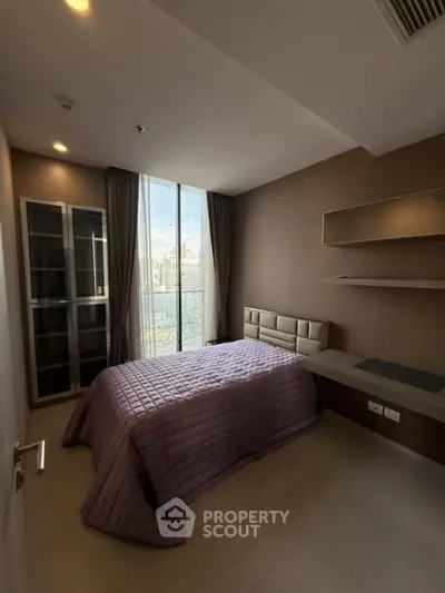 Modern bedroom with city view, featuring sleek design and ample natural light.