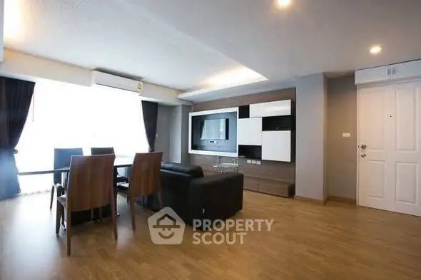 Spacious modern living room with sleek furniture and large windows for natural light.