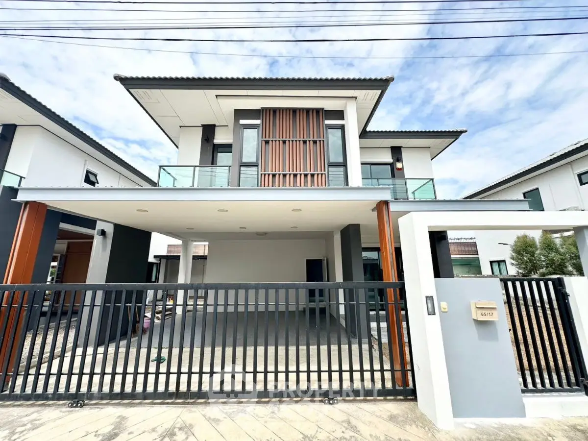 Modern two-story house with sleek design and spacious carport in a serene neighborhood.