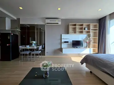 Modern open-plan living room with sleek furniture and natural light