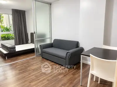 Modern studio apartment with sleek furnishings and hardwood floors