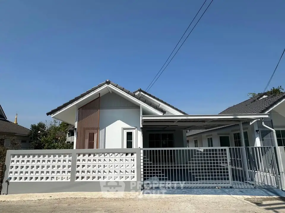 Charming single-story house with modern design and spacious driveway in a serene neighborhood.