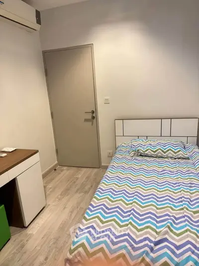 Cozy bedroom with modern decor and air conditioning, perfect for a comfortable living experience.