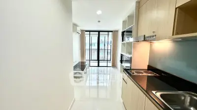 Modern apartment interior with sleek kitchen and bright living area