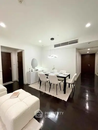 Elegant modern dining room with sleek furniture and ambient lighting in a stylish apartment.