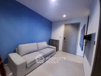 Modern living room with blue accent wall and comfortable sofa