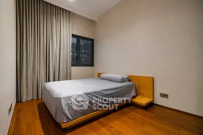 Cozy minimalist bedroom with wooden flooring and modern bed design
