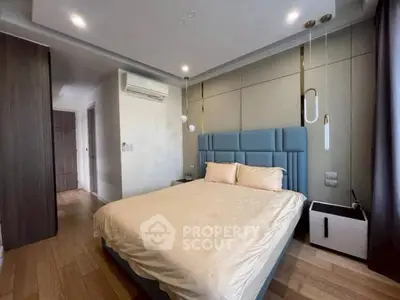 Modern bedroom with stylish decor and cozy ambiance, featuring a comfortable bed and elegant lighting.