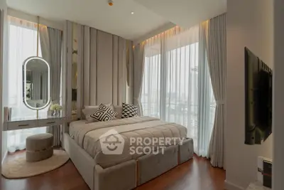 Luxurious bedroom with elegant decor and city view, featuring plush bedding and stylish furniture.
