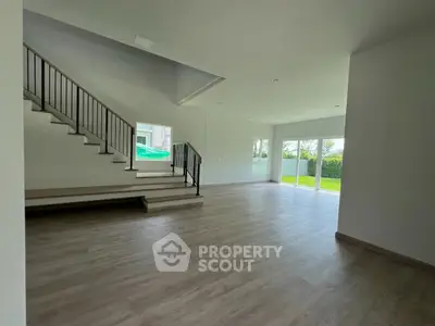 Spacious modern living room with large windows and garden view