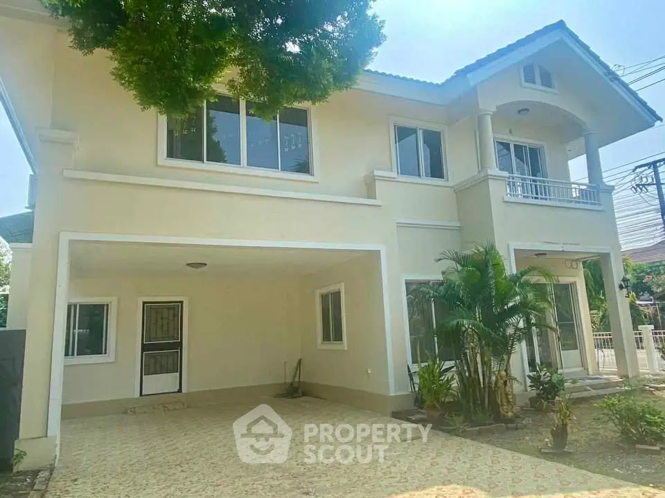 Spacious two-story house with garage and lush greenery in a serene neighborhood.