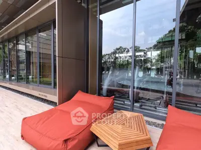 Modern outdoor seating area with stylish bean bags and geometric table, perfect for relaxation and leisure.